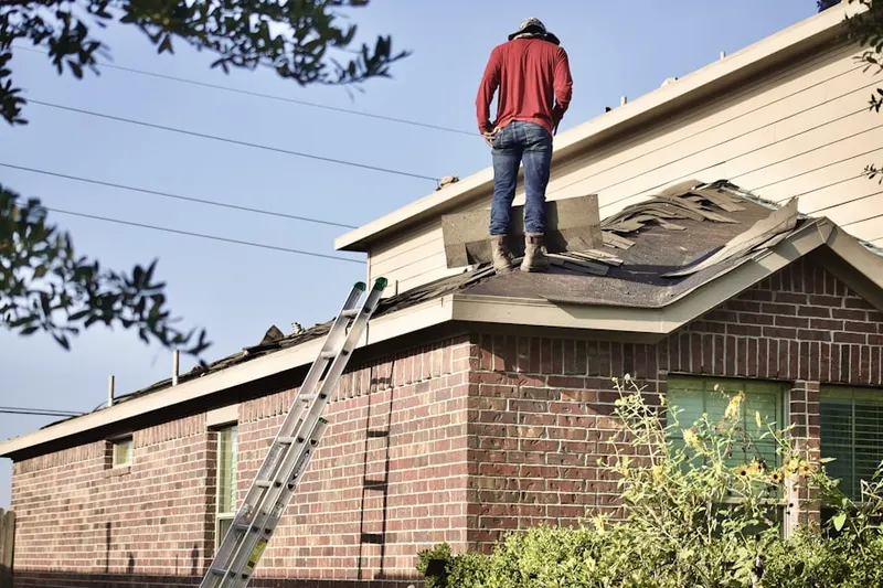 Professional roofer working on a residential roof in View Park